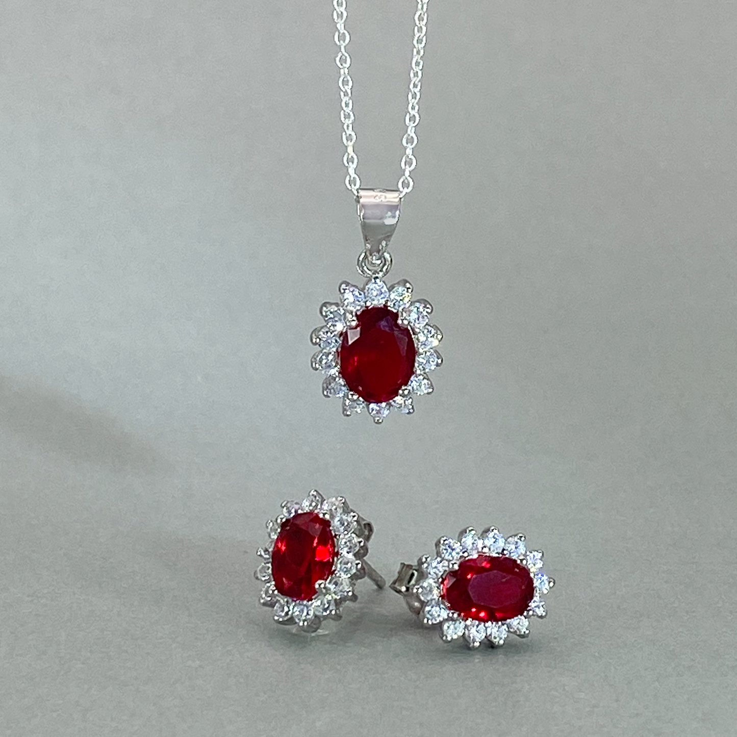 Silver CZ Red Oval (4mm) Centre Stone Cluster Earring & Pendant set
